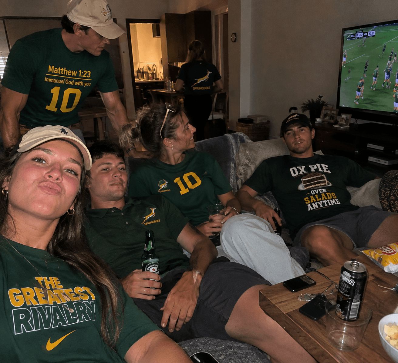 Friends on the couch watching the Springboks on TV
