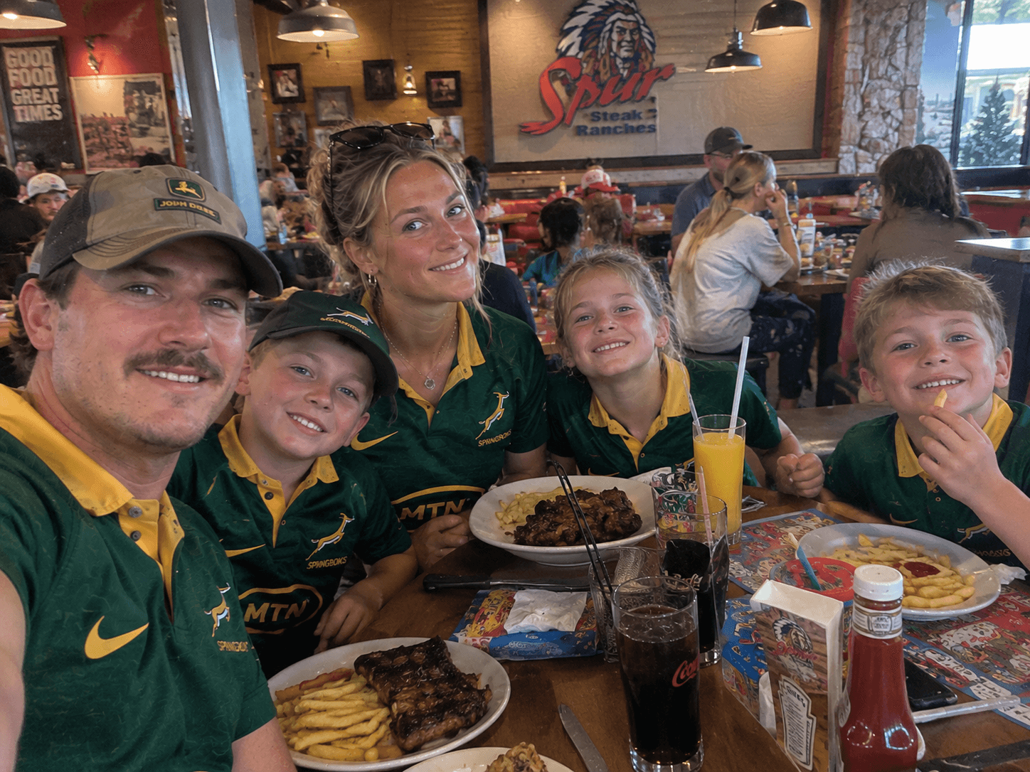 Family in Springbok shirts having a meal at Spur